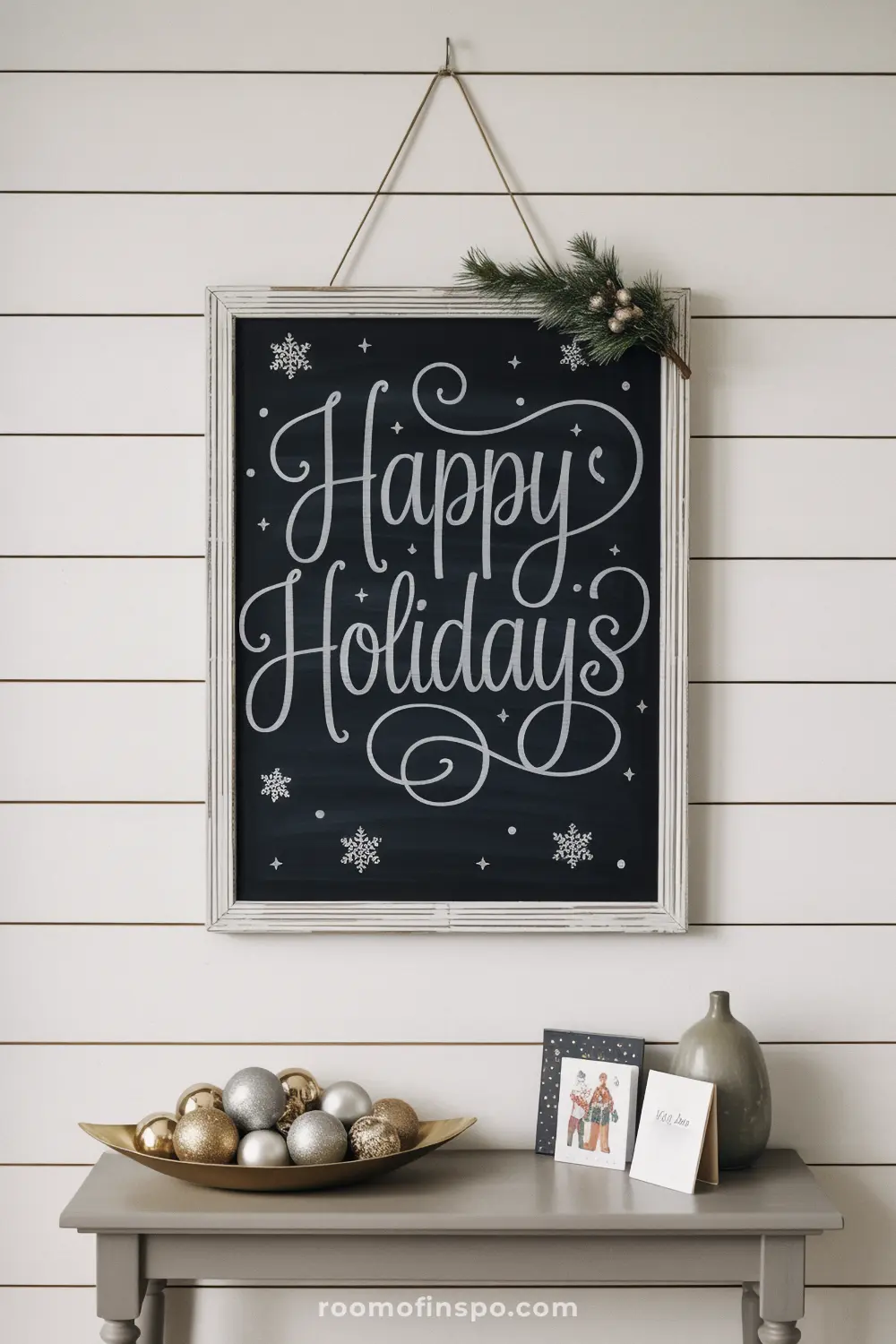 A "Happy Holidays" message in elegant script on a framed chalkboard with snowflake details creates a simple and classic Christmas decoration.