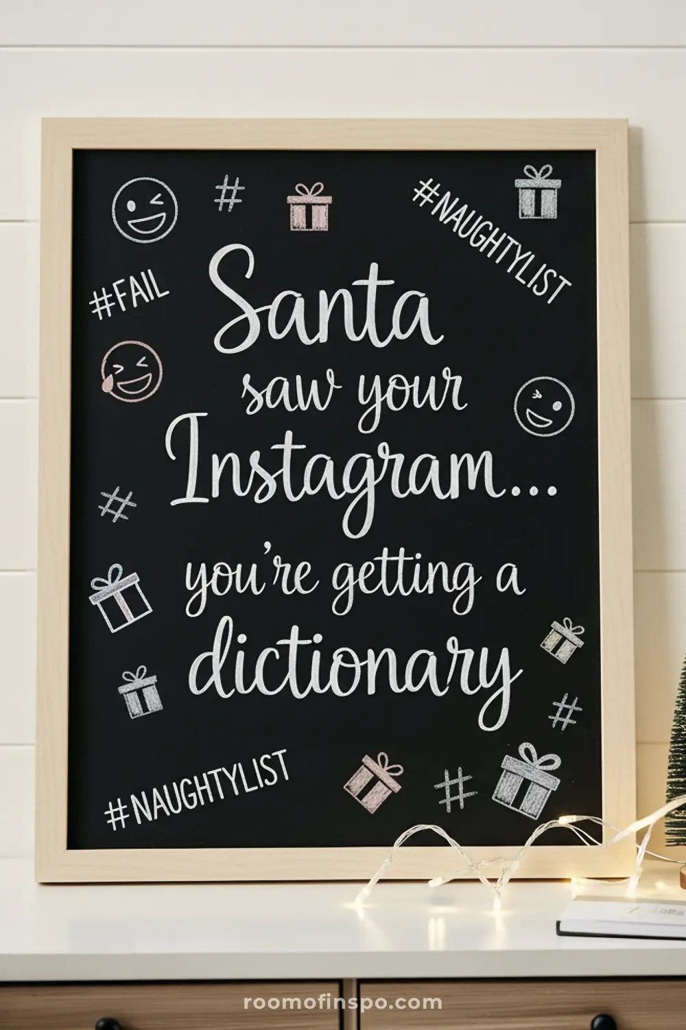 A funny Christmas chalkboard sign jokes that Santa saw your Instagram and is getting you a dictionary, complete with hashtag and gift drawings.