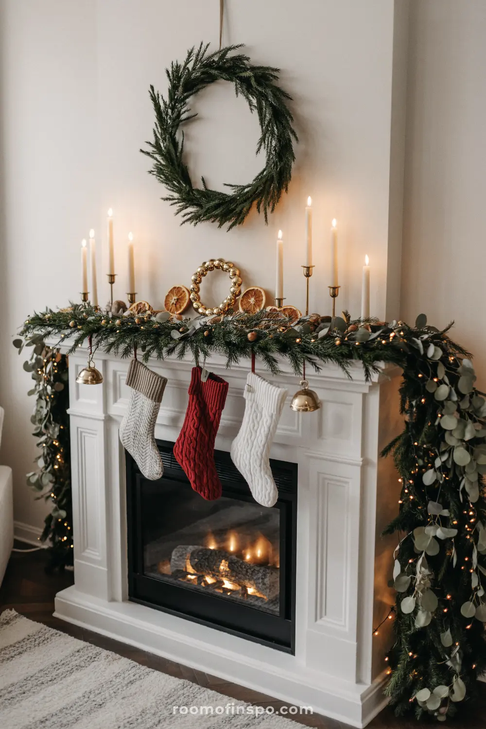 This classic living room fireplace is decorated with garland, wreaths, and festive knit stockings for Christmas.