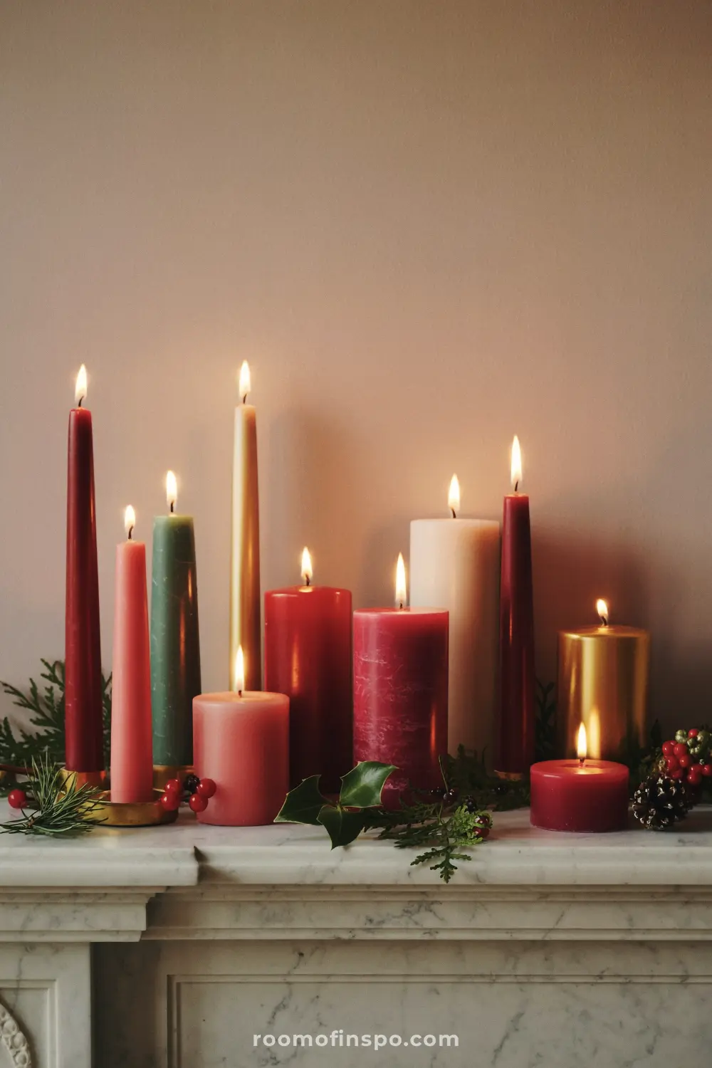 A traditional Christmas mantel decorated with a colorful array of lit pillar and taper candles in holiday hues and sprigs of greenery.
