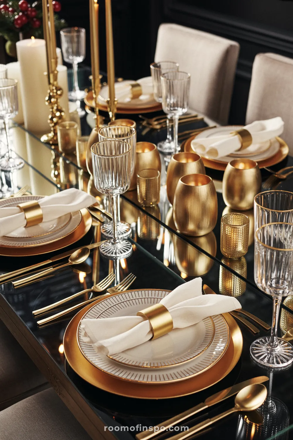 Mirror-top Christmas table setting with gold chargers, metallic napkin rings, matching gold flatware, and votives for a luxurious and festive glow.