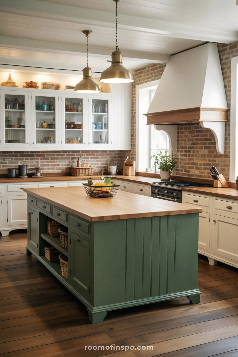 A traditional kitchen with a green island, oak countertop, and industrial brass pendants over brick backsplash.