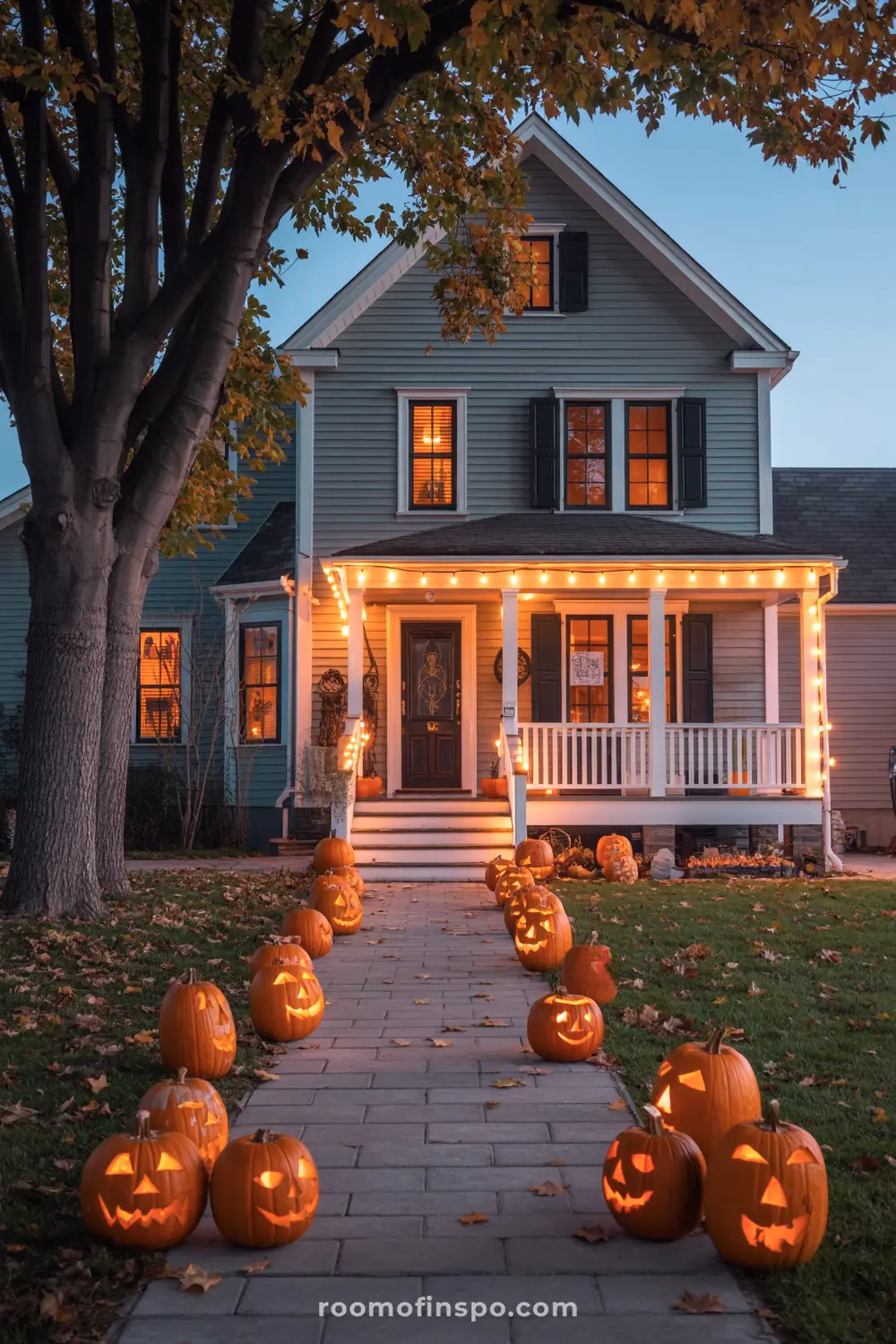A festive Halloween front porch and walkway are adorned with numerous glowing carved pumpkins and string lights on a charming house.