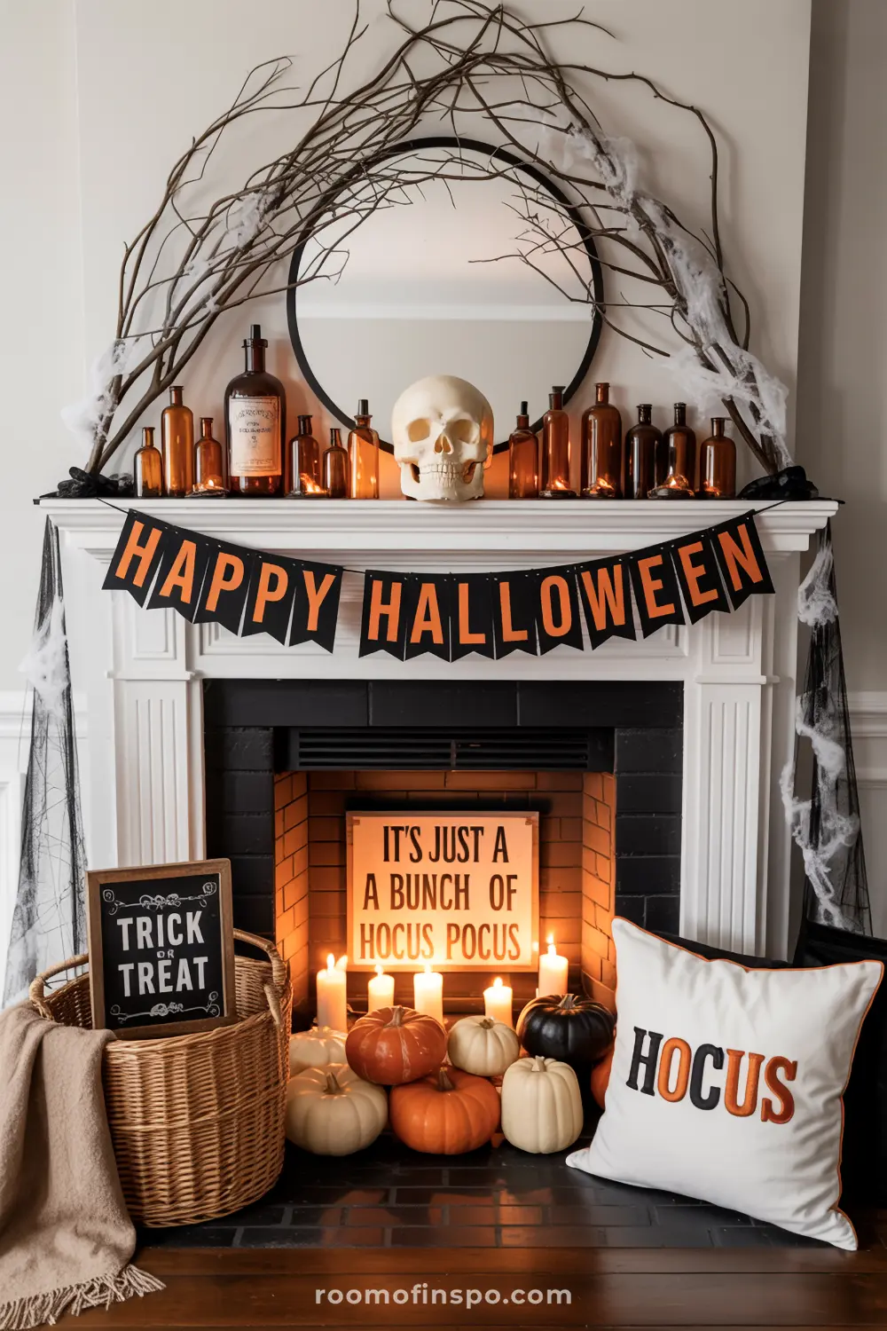 A Halloween mantel features a "Happy Halloween" banner, a skull, and dark branches, with pumpkins and candles below, creating a spooky display.