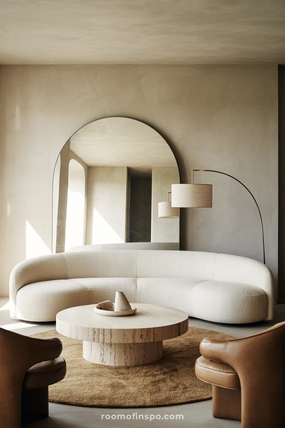 Dining room with oval oak table, rounded chairs, curved ceramic pendant, and arched doorway.