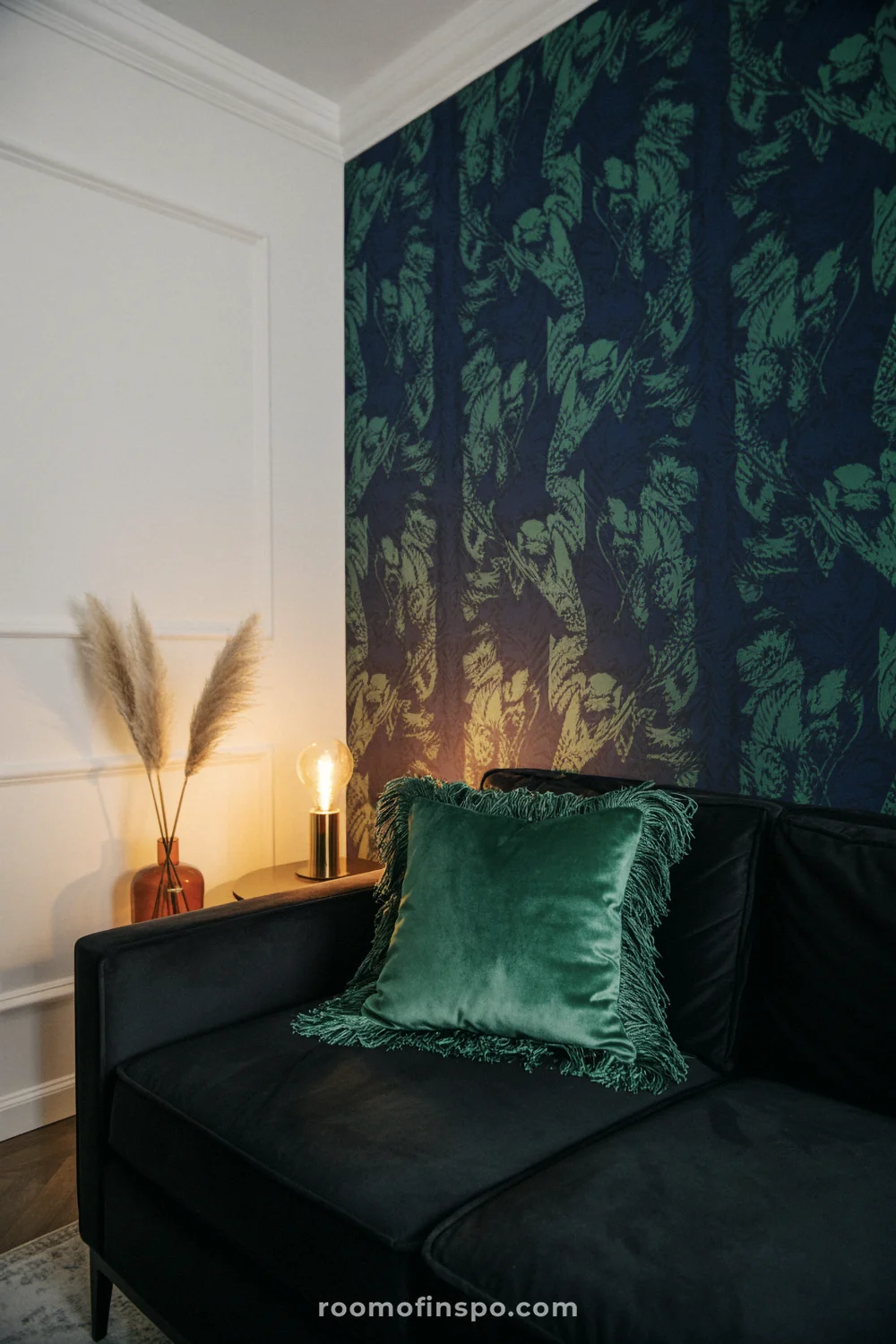 Dramatic accent wall with jewel-tone wallpaper, charcoal velvet sofa, and warm ambient lighting.