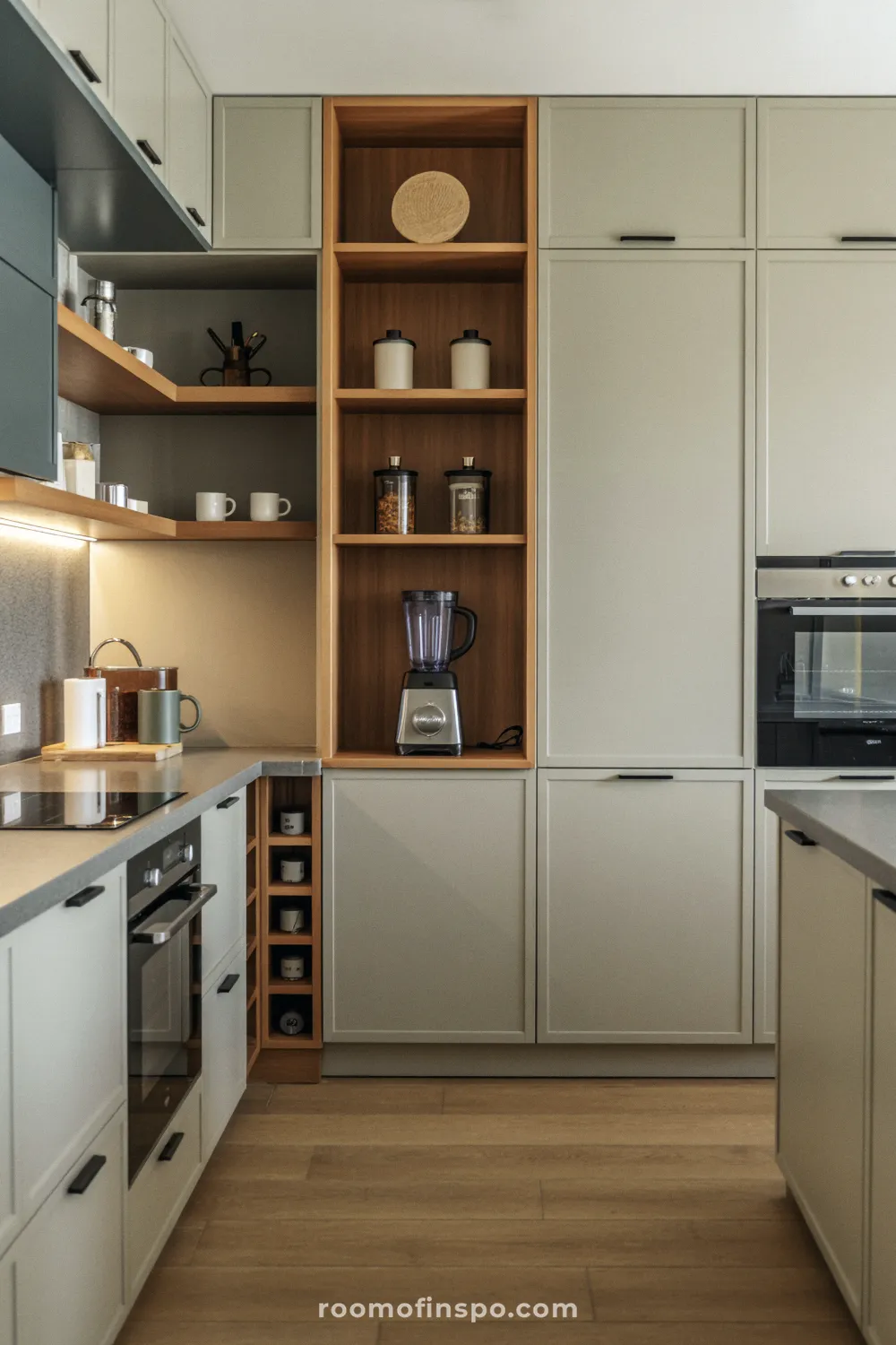 A warm, light-filled kitchen with a central island and light wood finishes, emphasizing a comfortable, family-friendly centerpiece.