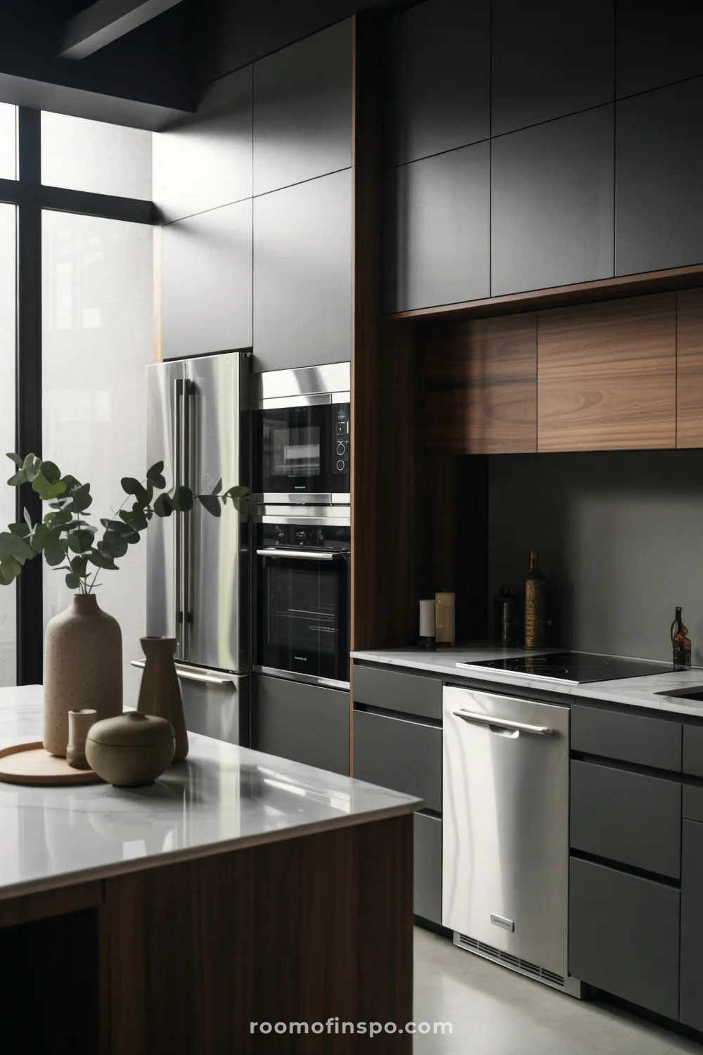 This high-end kitchen showcases fully integrated, built-in appliances and sleek, dark cabinetry for a seamless, modern look.