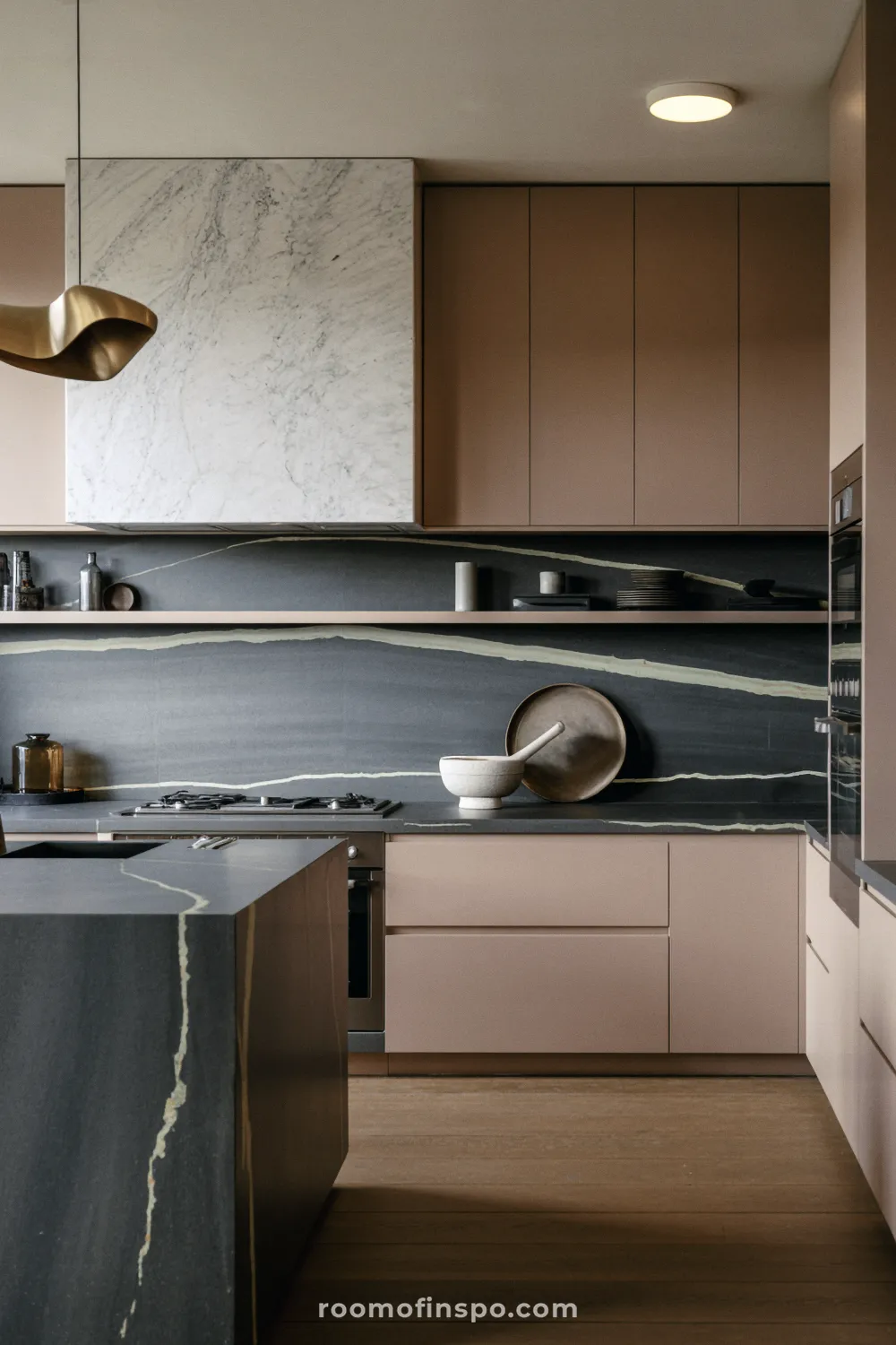 The modern kitchen features a continuous use of light, neutral stone on countertops and the backsplash, creating a seamless look.