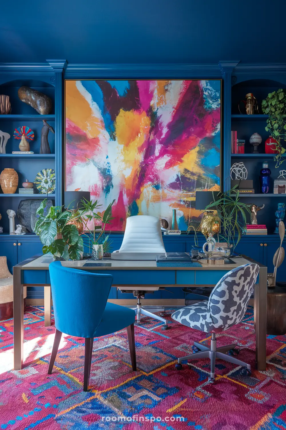 A maximalist home office with statement abstract artwork and laptop.
