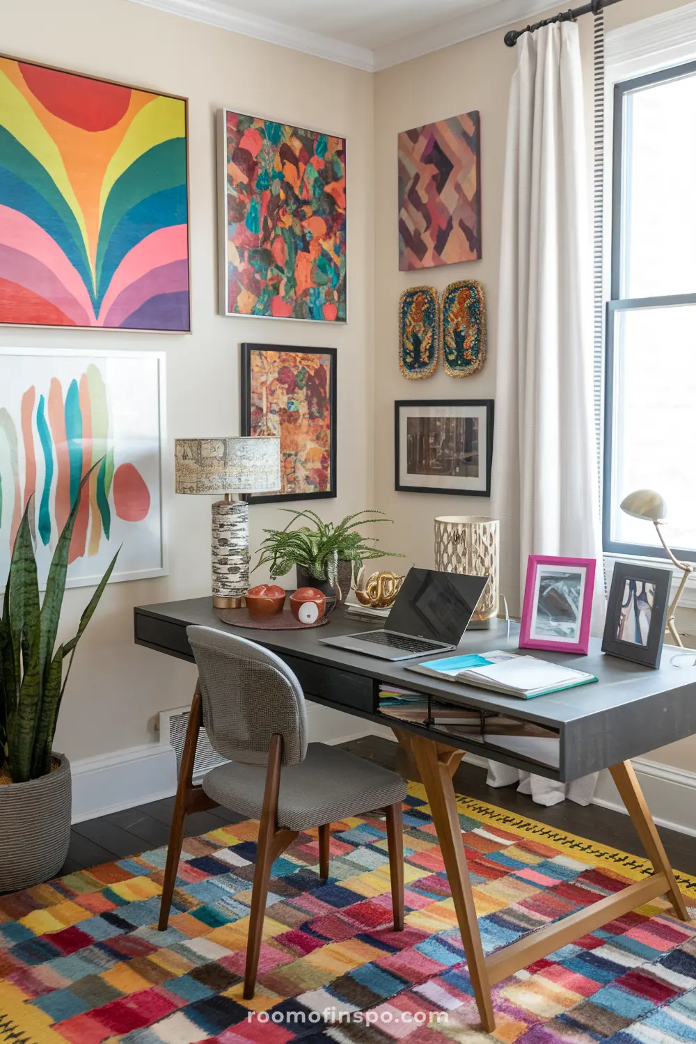 A maximalist home office with bold rugs and laptop.
