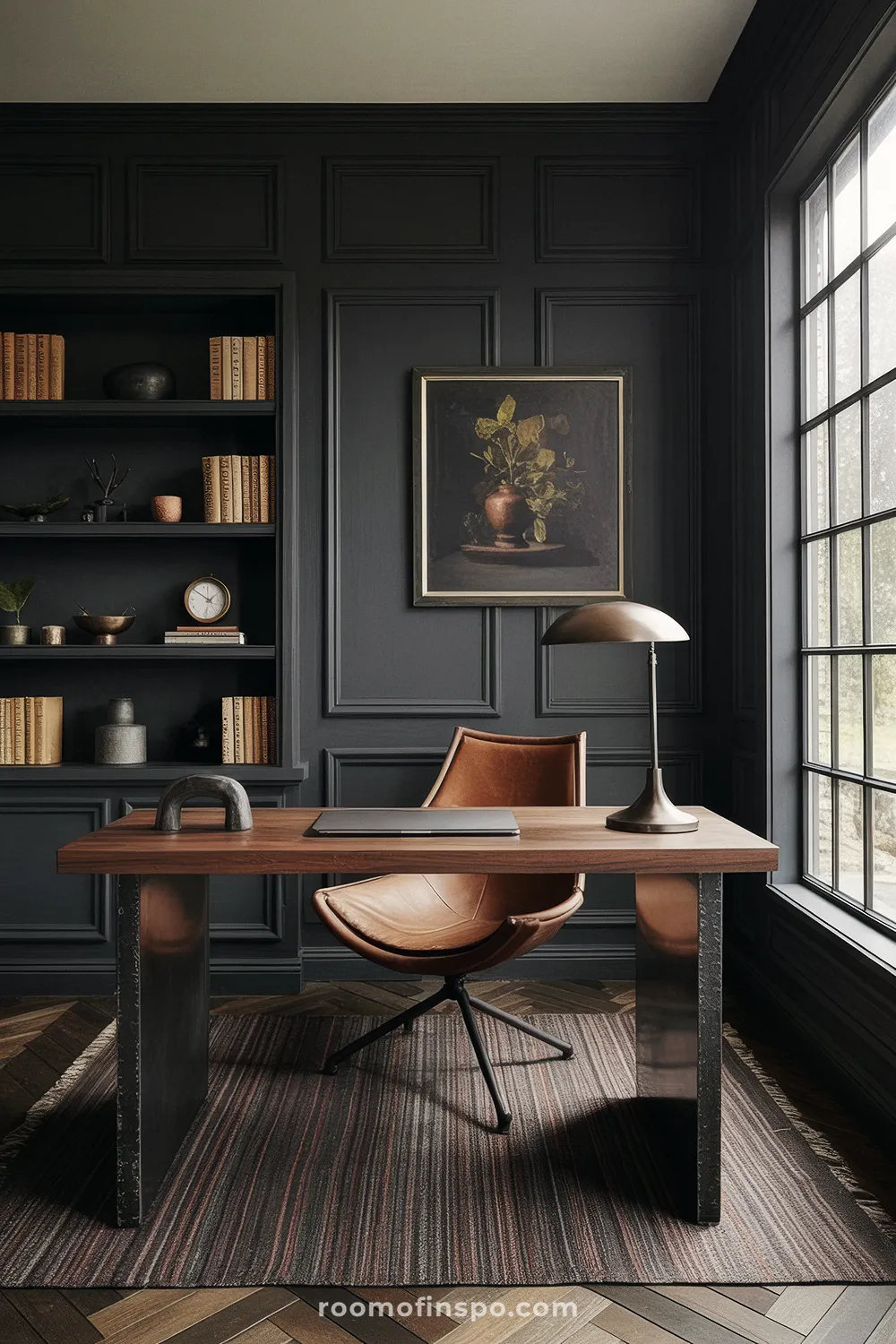 A dark gray home office with a leather chair and a wooden desk.