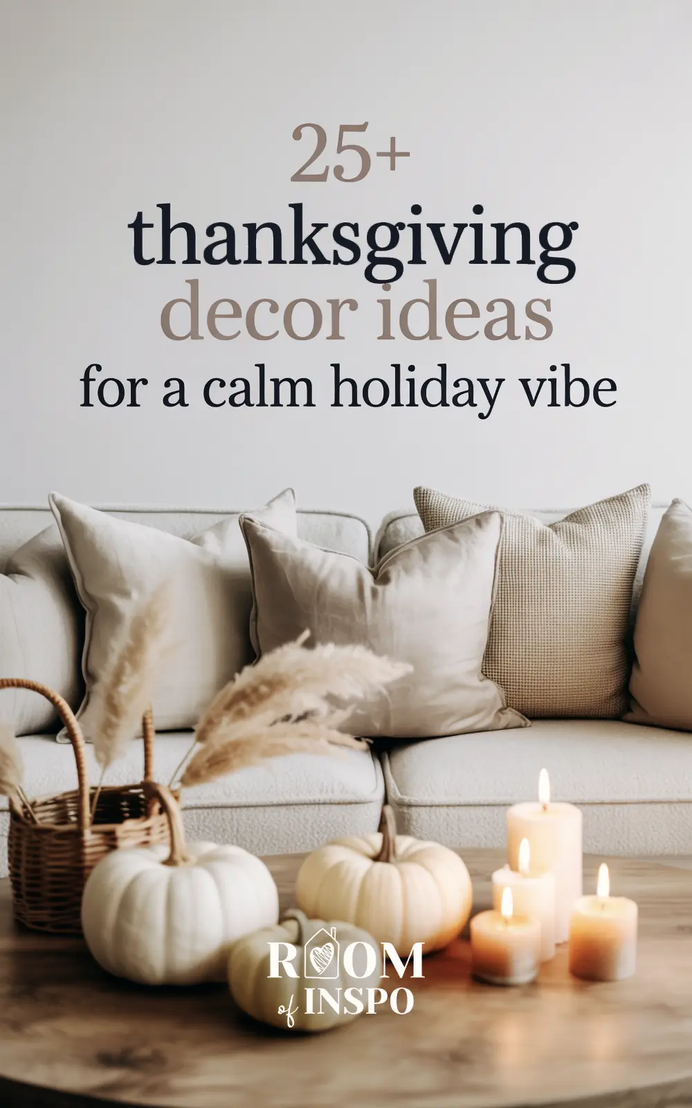 A living room coffee table decorated for a calm thanksgiving, with white pumpkins, a basket, and glowing candles.