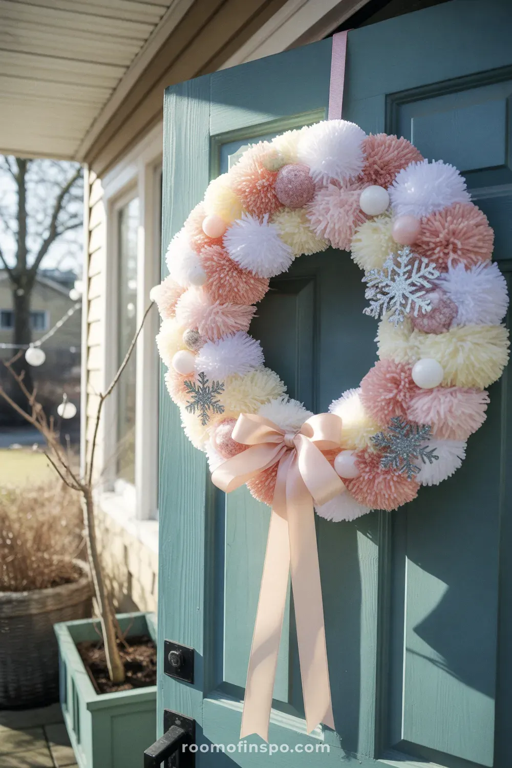 A playful winter wreath with a colorful pom-pom ring on a white foam circle, giving a light and cheerful design.