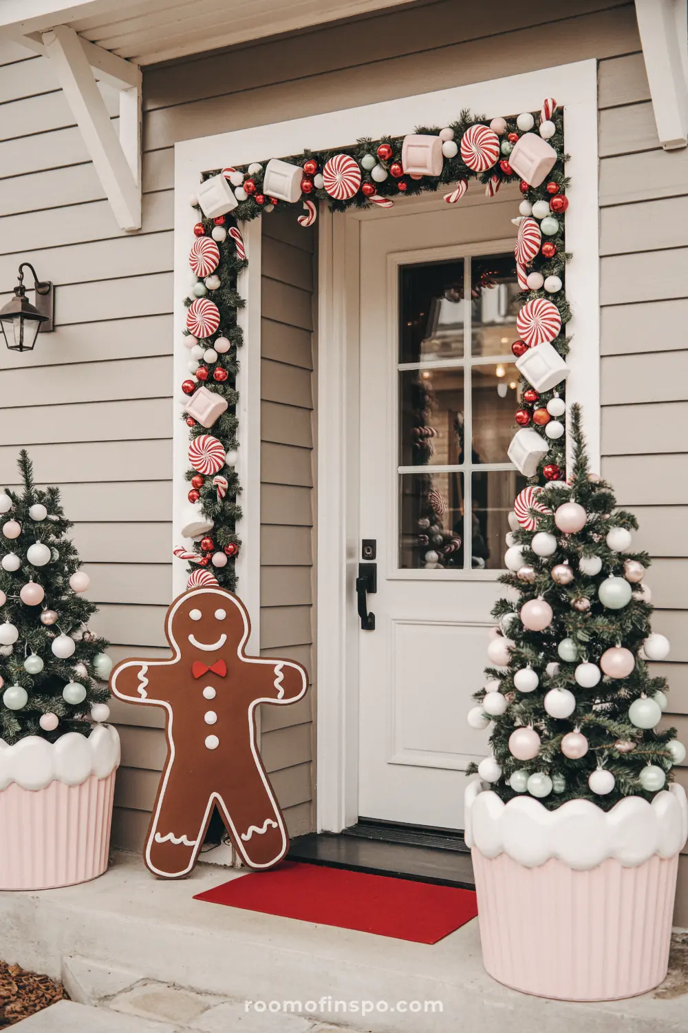 A fun gingerbread-themed Christmas porch with candy cane garland and a large gingerbread man cutout.