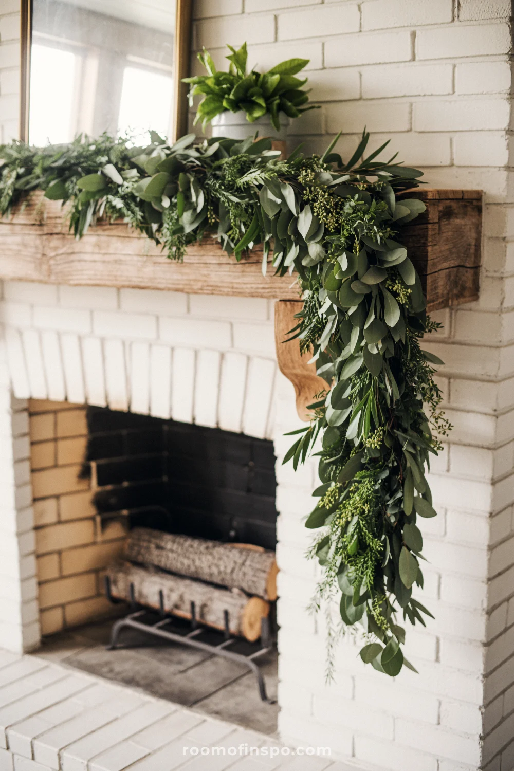 Rustic farmhouse living room with stone fireplace, wooden beam, and cascading green garland in soft natural light.