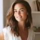 A woman with brown hair and a white shirt.